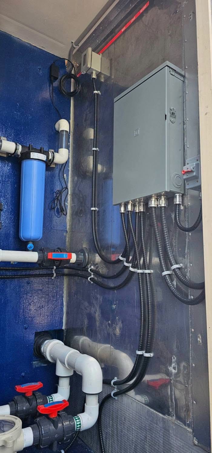 A water treatment installation with its control panel, valves and filtration piped in.